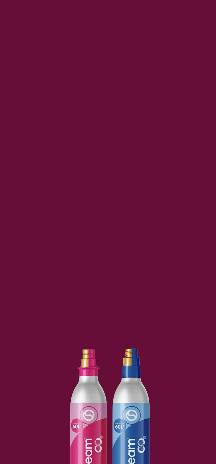 Pink and blue Sodastream CO2 cylinders on a maroon background