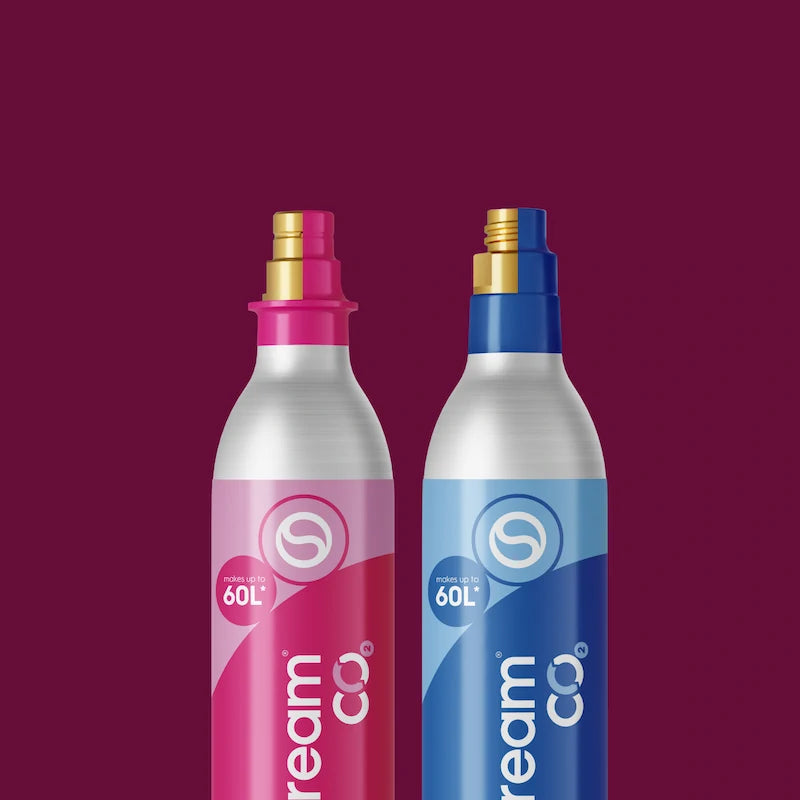 Pink and blue Sodastream 60L CO2 cylinders on a maroon background