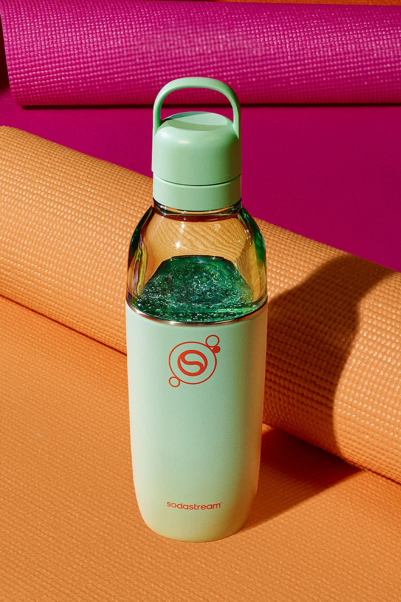 Sodastream Fizz & Go Easy Mix Mint bottle filled with sparkling water, on an orange yoga mat