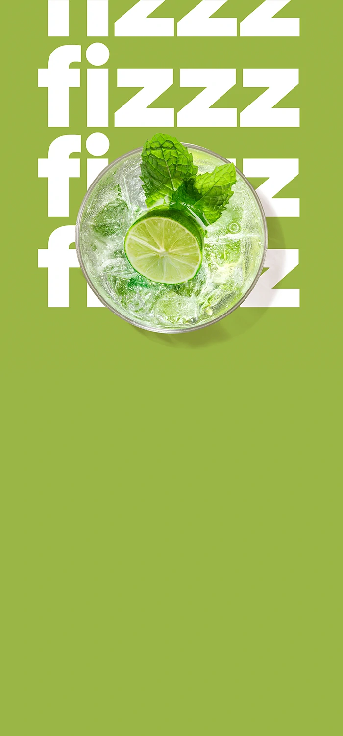 Sparkling drink with lime and mint on a green background with the word “fizzz”