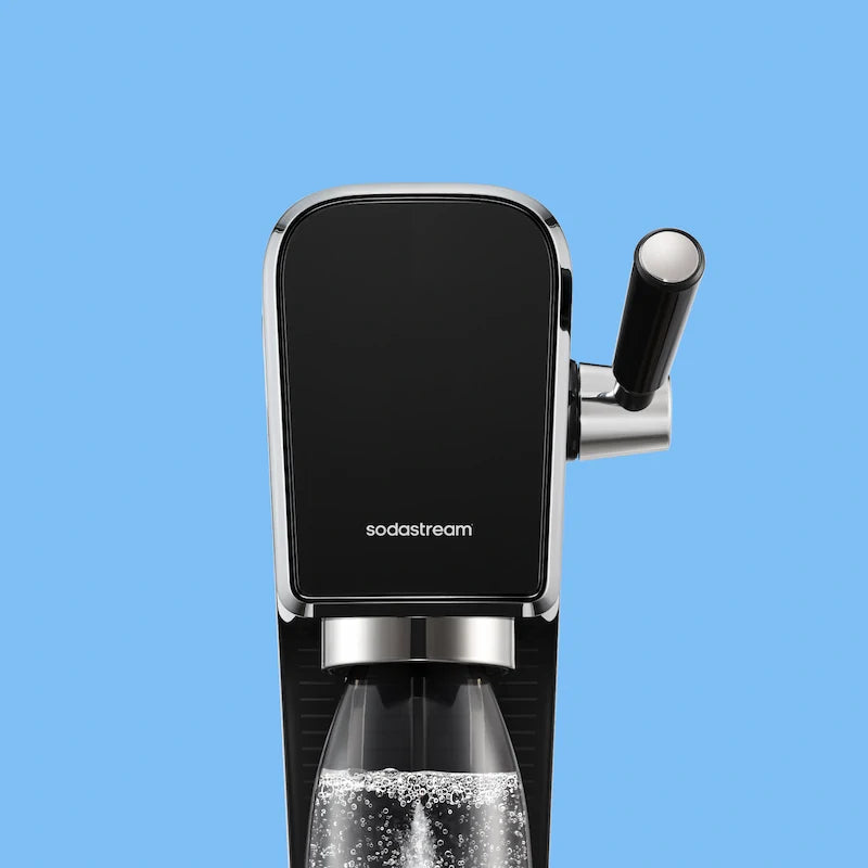 Close-up of the black Sodastream ART sparkling water maker on a light blue background